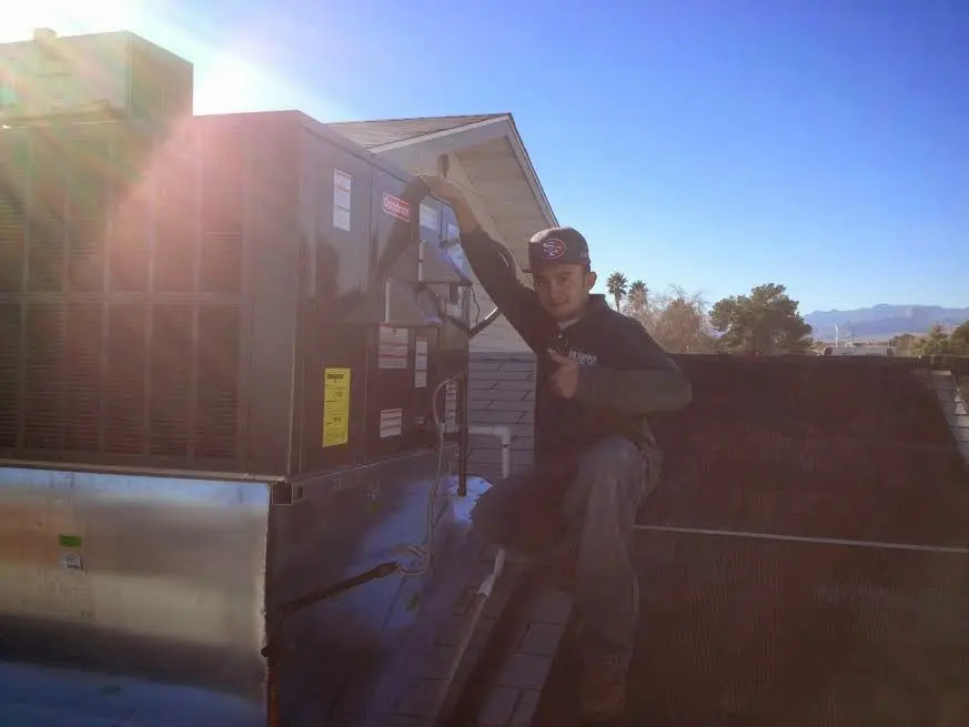HVAC technician performing HVAC Inspection on a rooftop unit in Mount Carmel